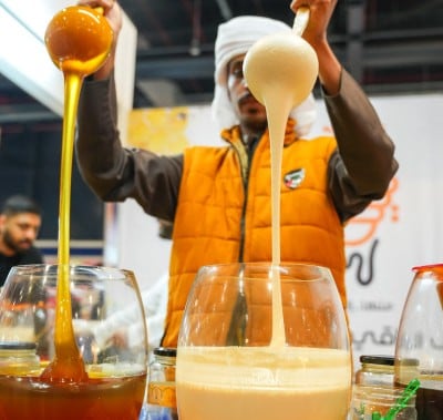 Exhibitor ladeling out honey
